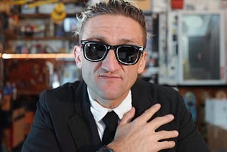 Casey Neistat looks into the camera with his signature spray-painted sunglasses