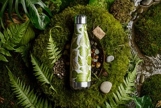 A sustainable water bottle with a nature-inspired background by AI Artz