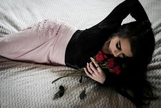 reclining on bed with roses