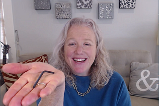 Betsy holding an Allen key in the palm of her hand
