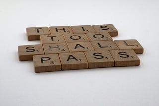 Scrabble blocks that spell out This Too Shall Pass