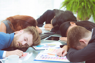 People sleeping at a business meeting.