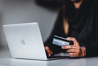 A woman who enters her bank details while shopping online.