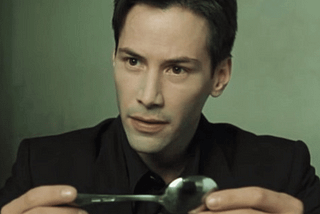 Neo (Keanu Reeves) holding a spoon in the Matrix.