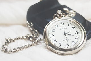 silver-colored time piece representing a non-deterministic finite-state machine.