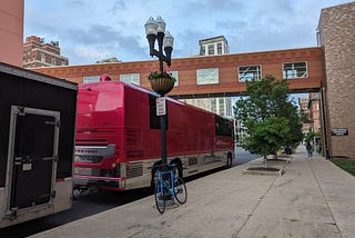 This shows a pink tour bus.