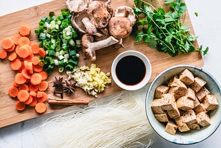 Chopping board full of vegetables and spices