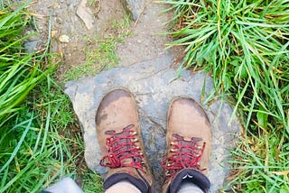 feet in Vivo barefoot walking boots on a grass lined path