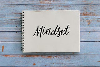 A notebook with the word mindset written on it.