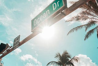 Green Ocean Dr. road sign under the sun