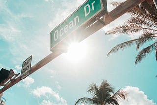 Green Ocean Dr. road sign under the sun