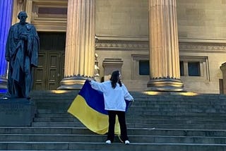 veronika stood on the steps of st george’s hall holding the ukraine flag