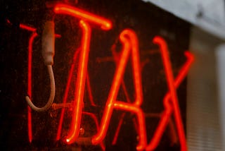 TAX in neon red