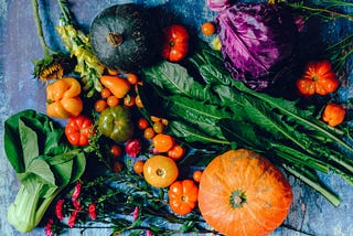 colorful photo of harvest of pumpkins, gourds, greens and cabbages