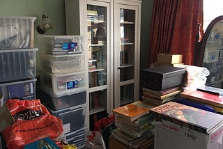 My father’s bedroom — bookcase, lots of plastic storage boxes and bags.
