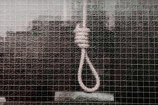 Black and white image of a noose of a hanging rope.