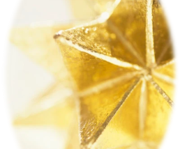An oval image with gold stars within it, one larger, then behind it, one softer looking