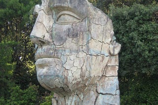 Large bronze statue of an expressionless face