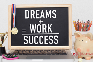 a chalkboard that says “Dreams+ Work = success” the chalkboard sits against a laptop and a gold medal is draped over it