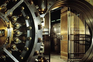 A bank vault door open.