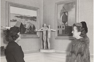two-women-admire-art-in-a-gallery-setting