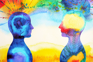 This is an image of two people looking at one another with colorful rainbows exploding from their minds.