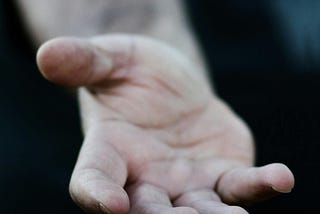 Man reaching toward camera with friendly hand