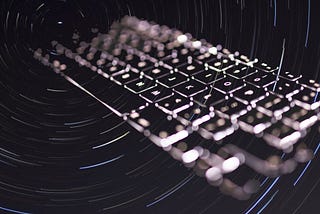 Keyboard flying out of a swirl of stars.
