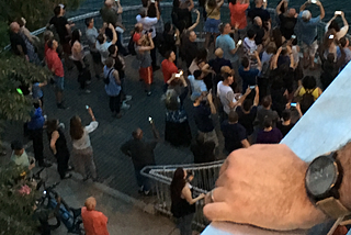A view of people clicking photographs on their cell-phones as the bats emerge at the famous bat-bridge in Austin, Texas