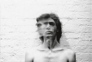 A 1973 self-portrait of American photographer Robert Mapplethorpe (moved, blurry face).