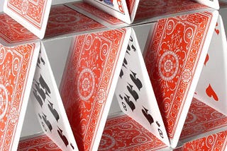 A phot of a house of cards, close up. Represents the idea of collapse, as a house of cards can easily do.
