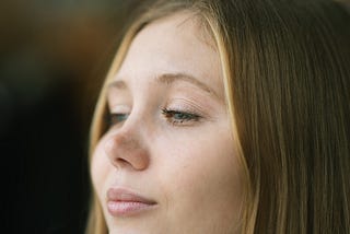 Young teen girl smiling in thought