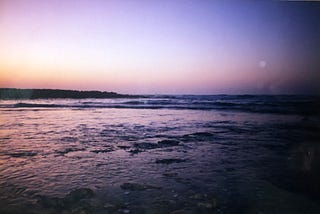 The ocean in a purple nightfall light.