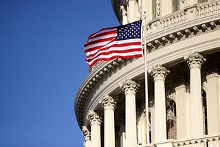 A flag flies outside the US Capitol.