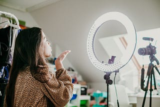 Young woman recording video for social media