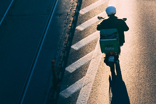 An uber eats driver on a moped