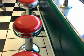 Red vinyl-topped stools in a diner