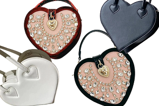 Various styles of heart shaped handbags. White heart shaped, red heart shaped, leather and velviet embellished