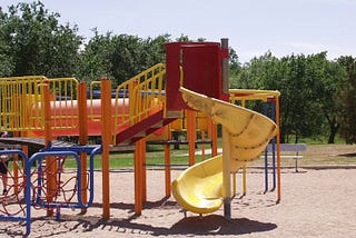 A brightly coloured children’s playground during the day