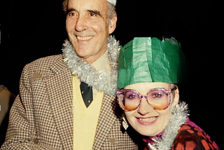 An inexplicable photo os Christopher Lee and Su Pollard, dressed in party hats and draped in tinsel, pulling a cracker. Both seem quite happy