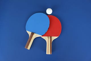 Red and blue ping pong paddles