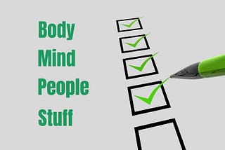 On the left are the words Body, Mind, People, and Stuff. On right is a pen checking off checkboxes next to those four words.