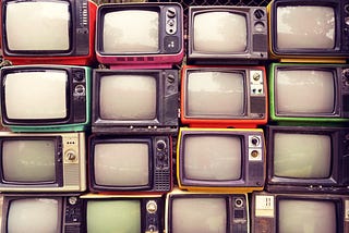 Photo of a stack of vintage TV sets.