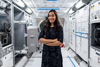 Women in Science, a photo of a smiling women aeronautical engineer working and posing with arms crossed