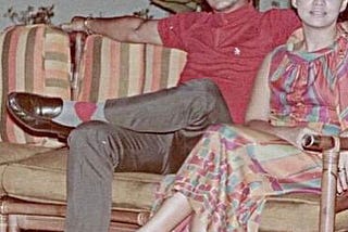 My grandfather and grandmother sitting in lawn chairs put out for a party in the D. Tuazon house. Circa 1960s.