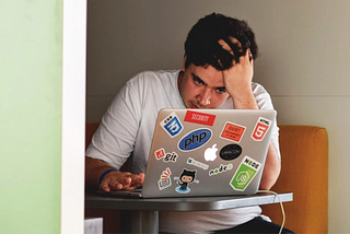 Stressed man working on laptop