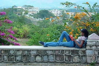 “Young Woman Reads Overlooking Santiago de Cuba — Cuba”