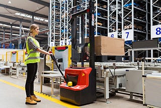 A woman operating a forklift