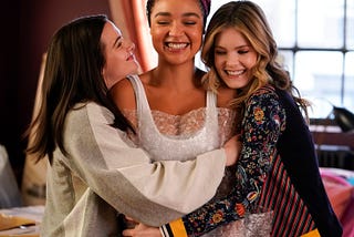 Three women, who are friends, hugging each other in a moment of tenderness.