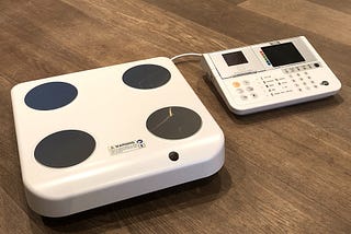 photo of body composition scales and analysis unit on wooden floor